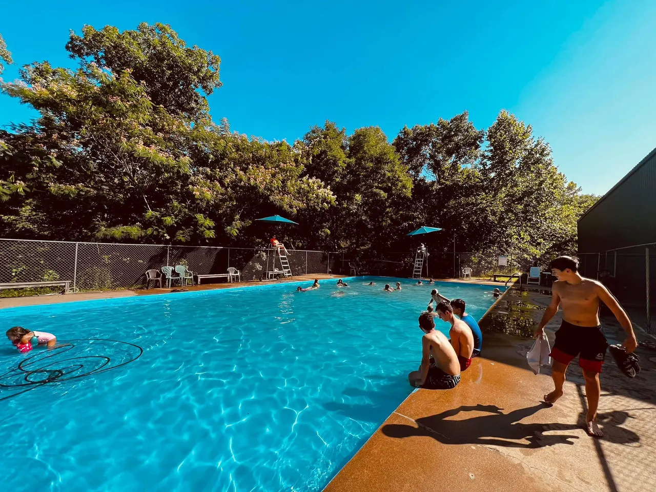 Campers enjoying a sunny afternoon at the Dayspring pool