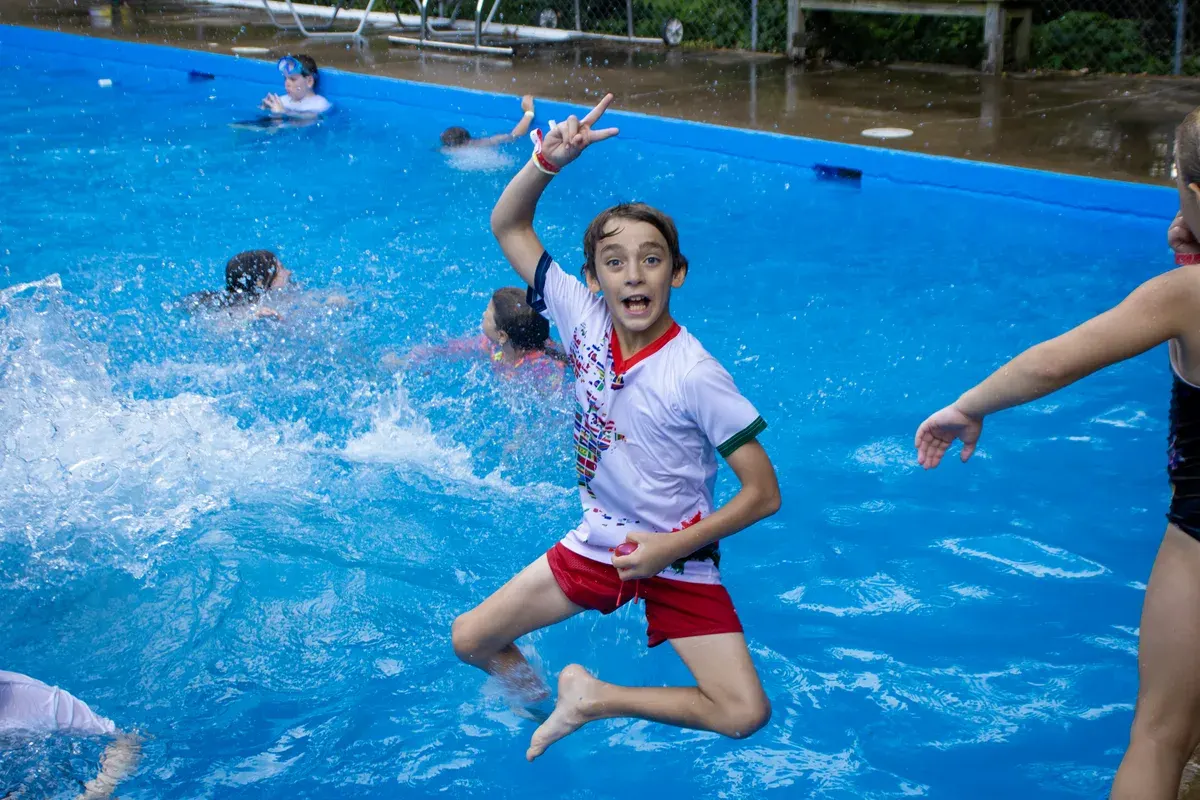 Campers splashing and playing in the Dayspring swimming pool